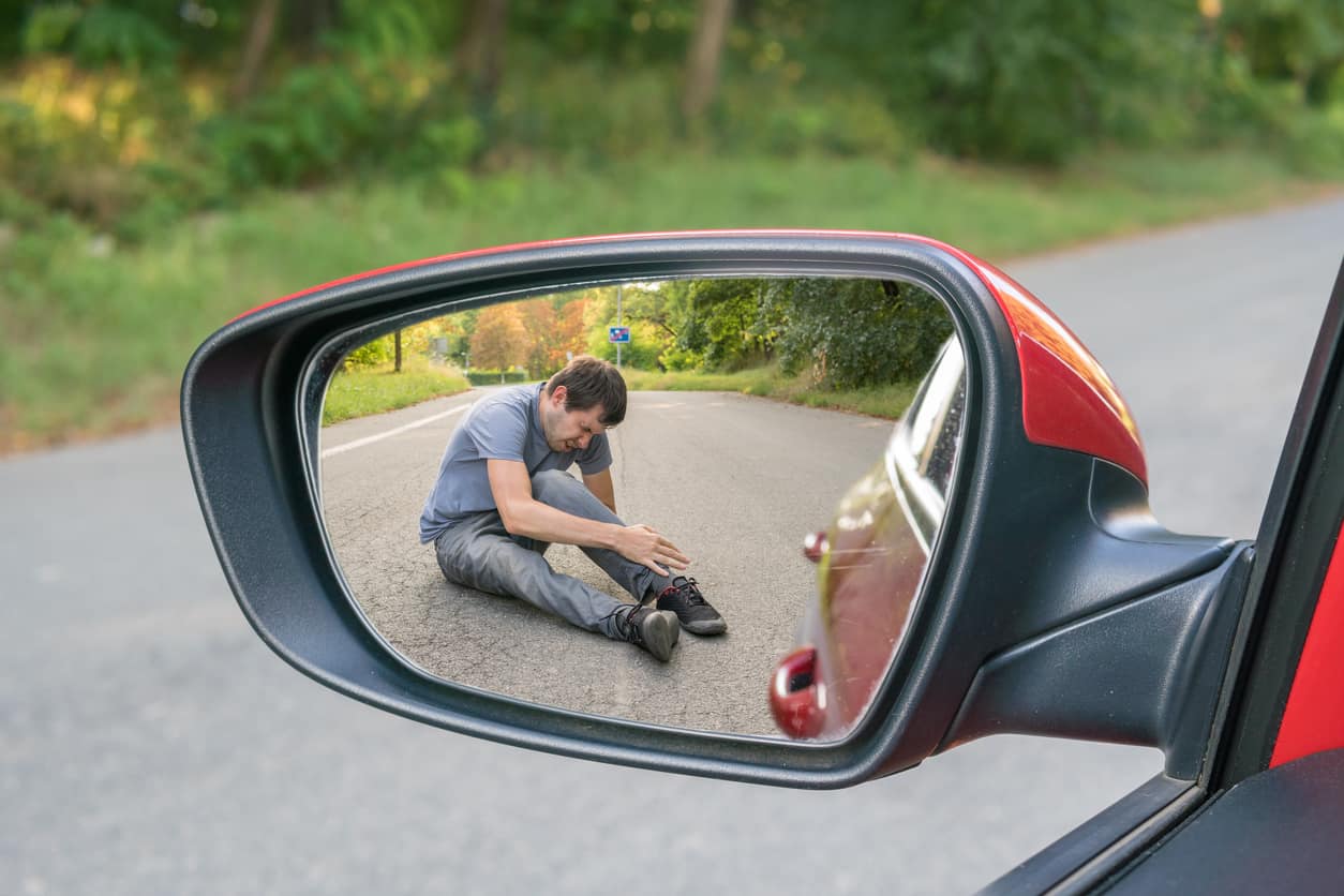 Driver checking for damages after a hit-and-run accident